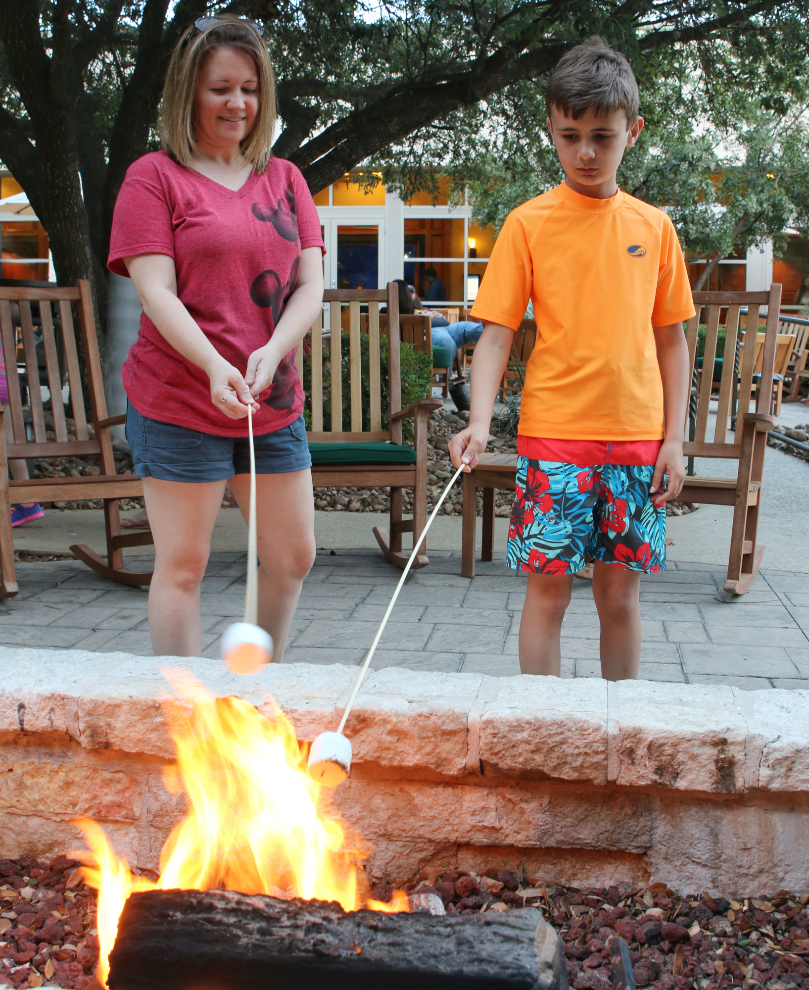 family making s'mores outside at Hilton hotel in san antonio