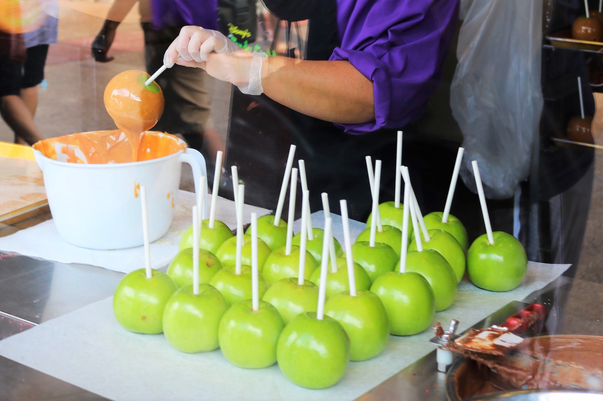 making candy apples at Disney Springs