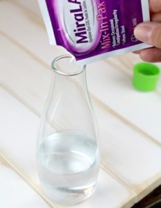 pour MiraLAX in water to mix